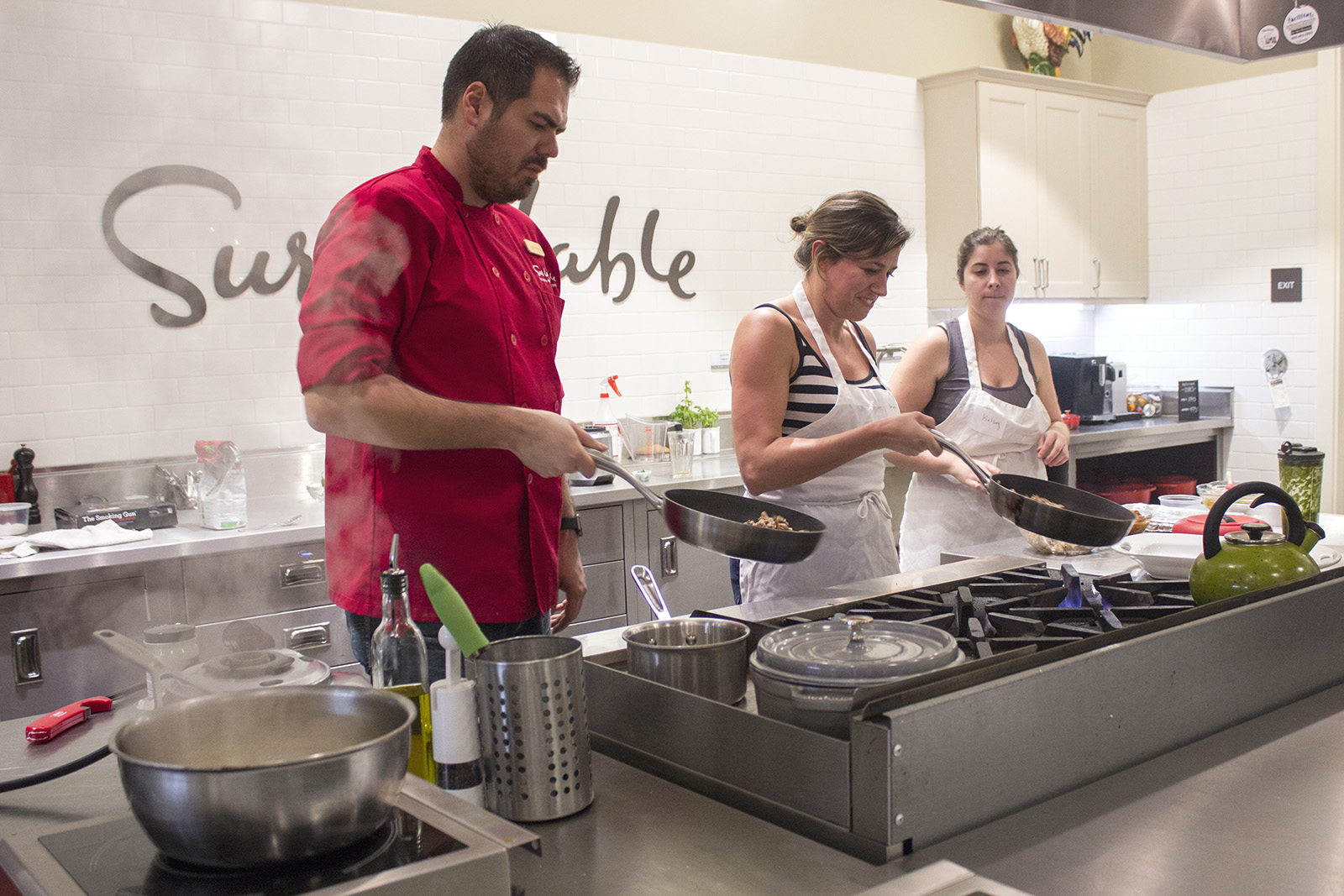 Student tests out taco technique at Sur La Table cooking class - Daily