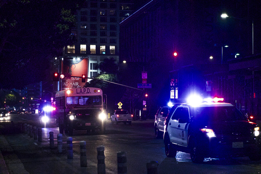 After several arrests of protestors were made just blocks from the Staples Center, a swarm of police vehicles and detainee vans sped down Figueroa Avenue towards the scene.