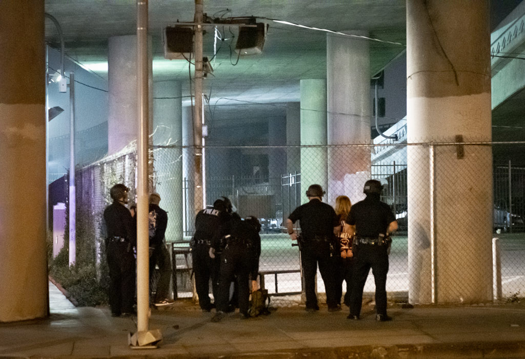 Anti-Trump protestors are handcuffed and searched by LAPD officers underneath an Interstate 10 overpass. The protestors marched from Staples Center and disrupted traffic flow around Figueroa and Grand, disobeying the dispersal order issued by LAPD for election night.