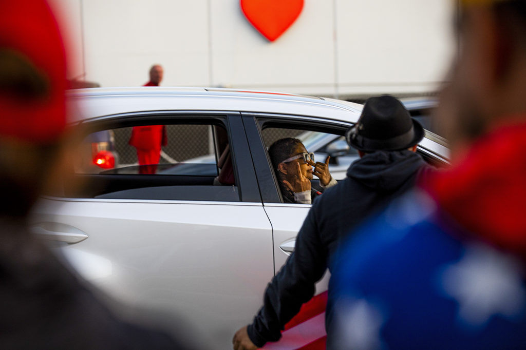 While many cars passing by the Trump rally honked in support of the demonstrators, some expressed their discontentment. One driver did so by displaying two raised middle fingers.