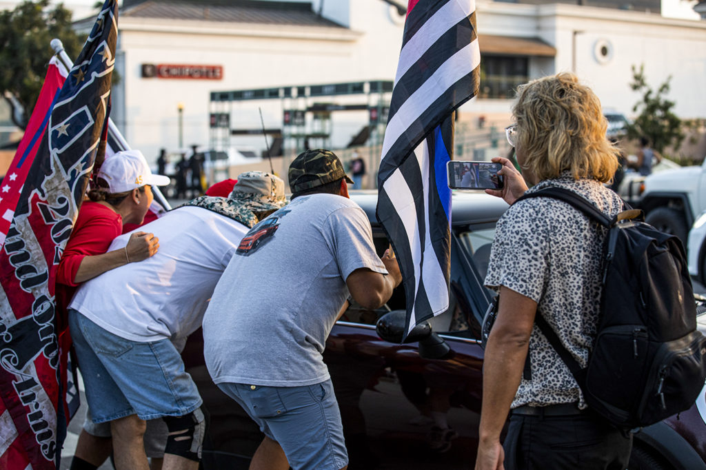 Pro-Trump demonstrators shouted at cars driving down Santa Monica Boulevard, with some demonstrators reaching into open passenger windows. At least two such alterations were broken up by LAPD Tuesday.