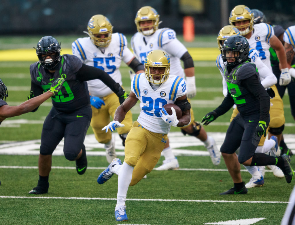 Brown runs the ball downfield, avoiding the Ducks' defense.