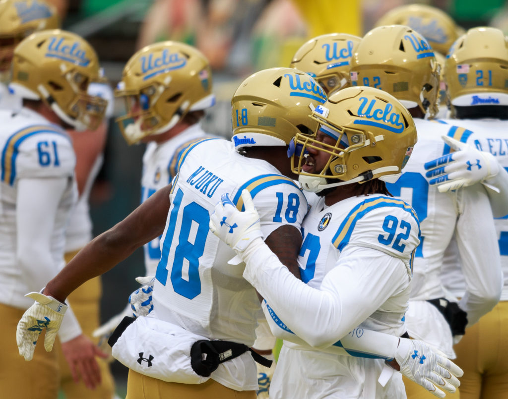 UCLA players gather on the field before the game against No. 11 Oregon. The Bruins have not played at Autzen since 2018.