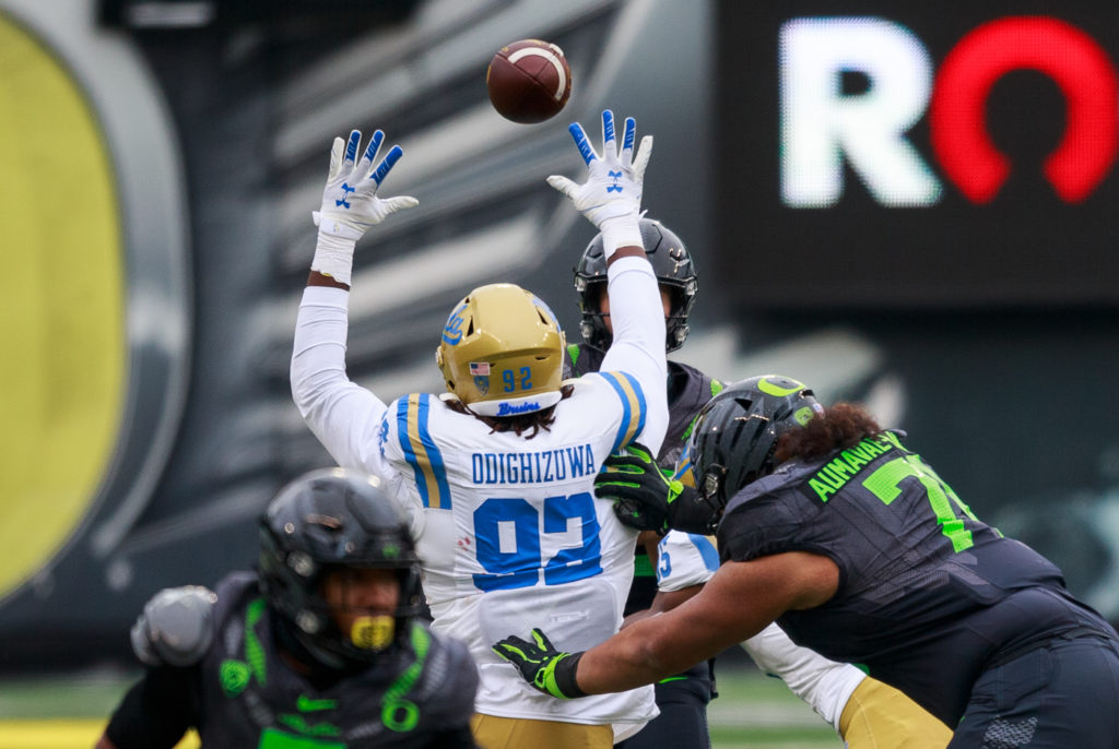 Redshirt senior defensive lineman Osa Odighizuwa attempts to block a pass by Oregon quarterback Tyler Shough.
