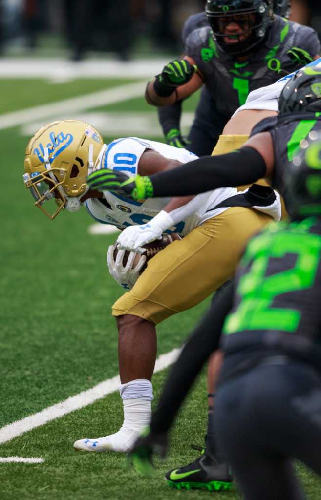 Felton runs down the middle, wrestling out of the grip of Oregon's defenders. Felton posted 167 rushing yards, a career – and game – high.