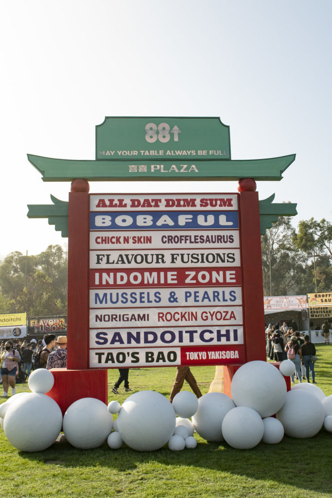 With a large pagoda-esque sign stating "May Your Table Always Be Full," vendors such as All Dat Dim Sum and Crofflesaurus kept festival goers fueled and tables full – until performers began to take the stage. (Alex Driscoll/Daily Bruin staff)