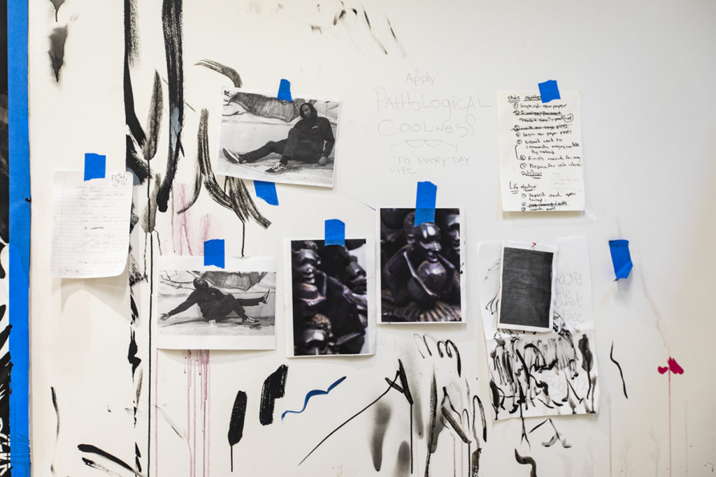 Notes are taped to the wall of a studio filled with Cisneros' work.  Cisneros said his pieces engage conversations about gentrification and marginalization, especially in his Los Angeles home.  (Anya Yakimenko/Daily Bruin)