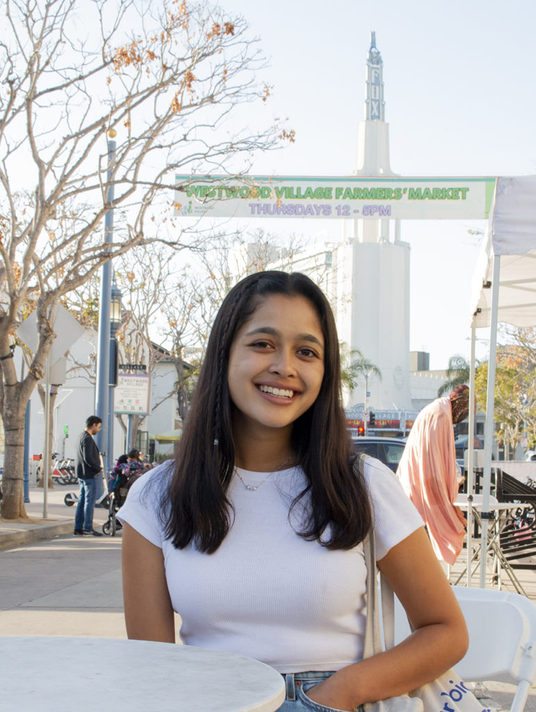 Laila Adarkar poses at the Westwood Farmers' Market. Adarkar said she distributes her own meal kits in collaboration with the Farmer's Market at UCLA and the UCLA Semel Healthy Campus Initiative Center. For Adarkar, sharing food with friends and family became a point of connection during the COVID-19 pandemic. (Megan Cai/Daily Bruin)