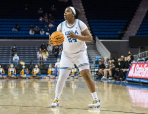 Graduate student forward IImar’I Thomas holds the ball on the perimeter. Thomas recorded 18 points and 10 rebounds before fouling out in the third overtime period. (Marc-Anthony Rosas/Daily Bruin)