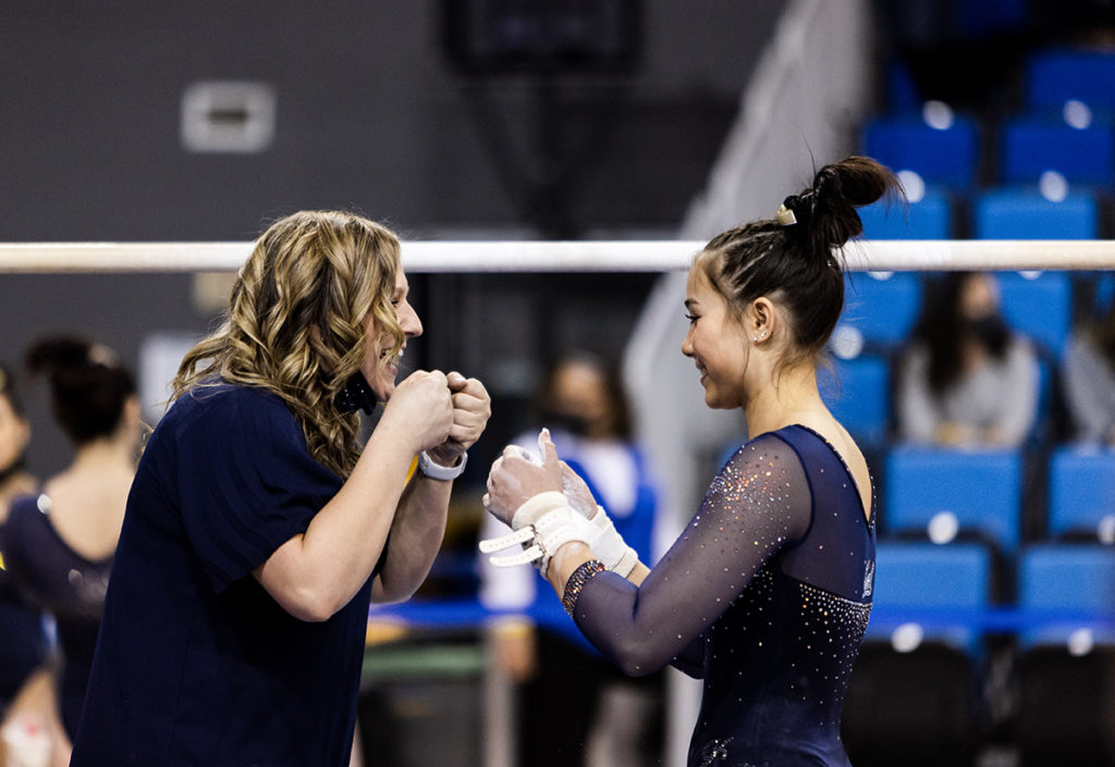 McDonald fist bumps a Cal gymnast. (Courtesy of Cal Athletics)