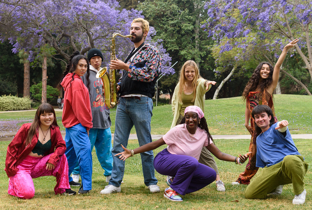 Outspoken members pose around one member as they play the saxophone. Anderson .Paak&squot;s "Am I Wrong" is part of the music component, where spoken word and improvisational elements are layered on top of the track. (Jeremy Chen/Daily Bruin staff)