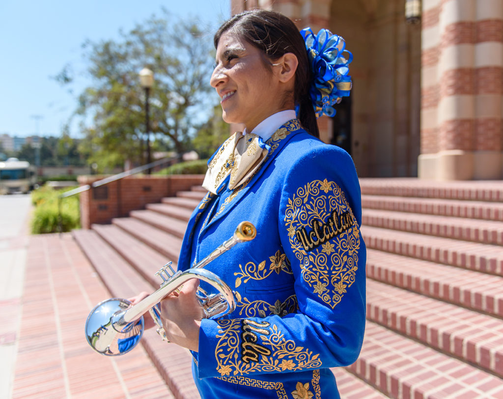 Fourth-year, ethnomusicology student and trumpet player Samantha Cabral smiles and holds her instrument. The ensemble is composed of guitar, violin, trumpet, guitarrón and vihuela players. (Sandra Ocampo/Daily Bruin)