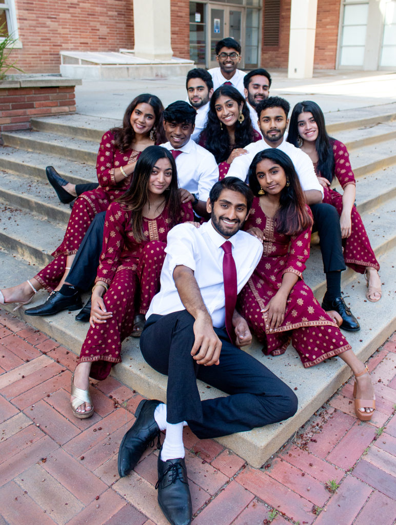 Naya Zamaana members sit in a diamond shape, staggered across steps. In additional to elements of traditional a cappella, the group will also incorporate rhythmic elements of Indian music and dance into their Spring Sing performance. (Megan Cai/Daily Bruin)