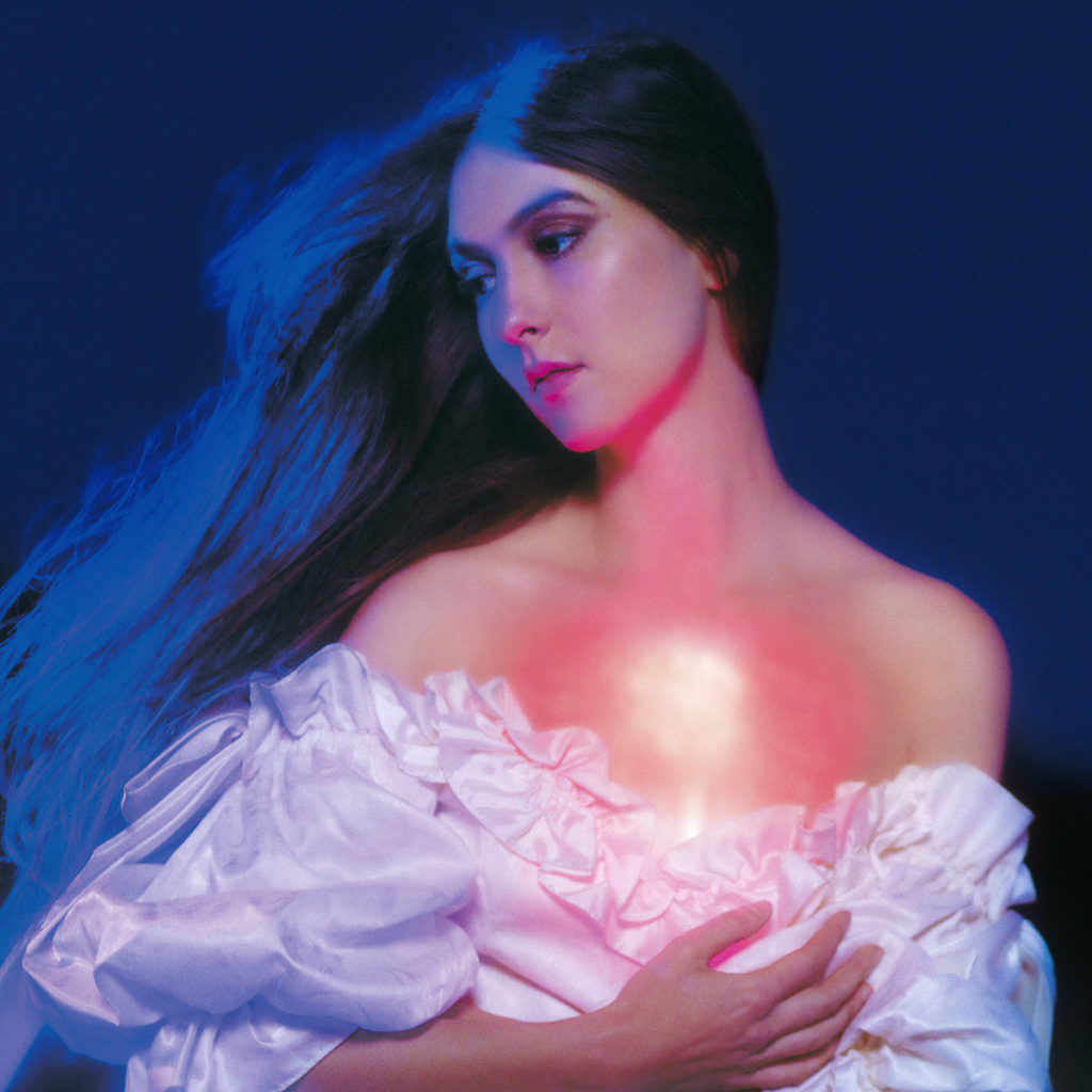 Weyes Blood is lit up with blue and pink tones on the cover of his second album, "In darkness, hearts on fire," which will be released on November 18.  (Courtesy of Sub Pop Records)