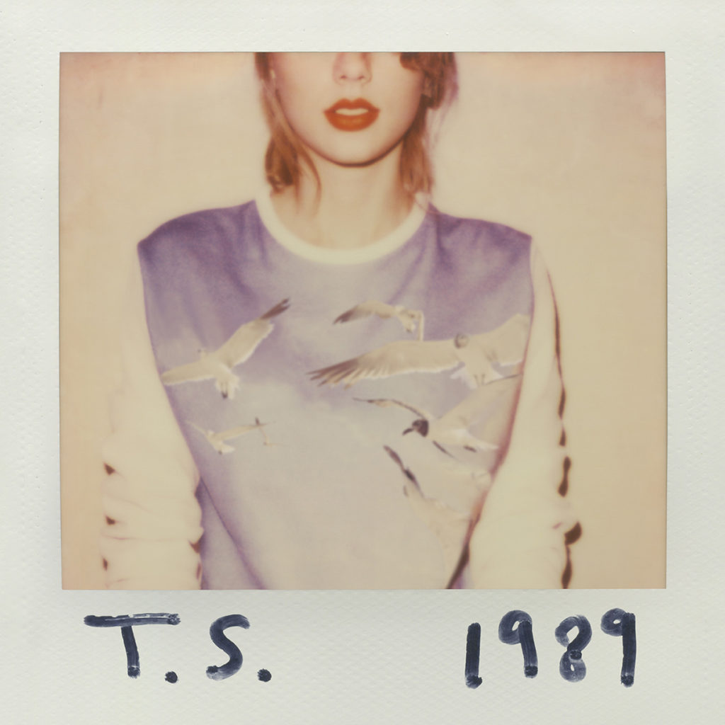 Taylor Swift wears a sweatshirt featuring a blue sky and seagulls on the polaroid cover of her fifth album, "1989." (Courtesy of Big Machine Records)