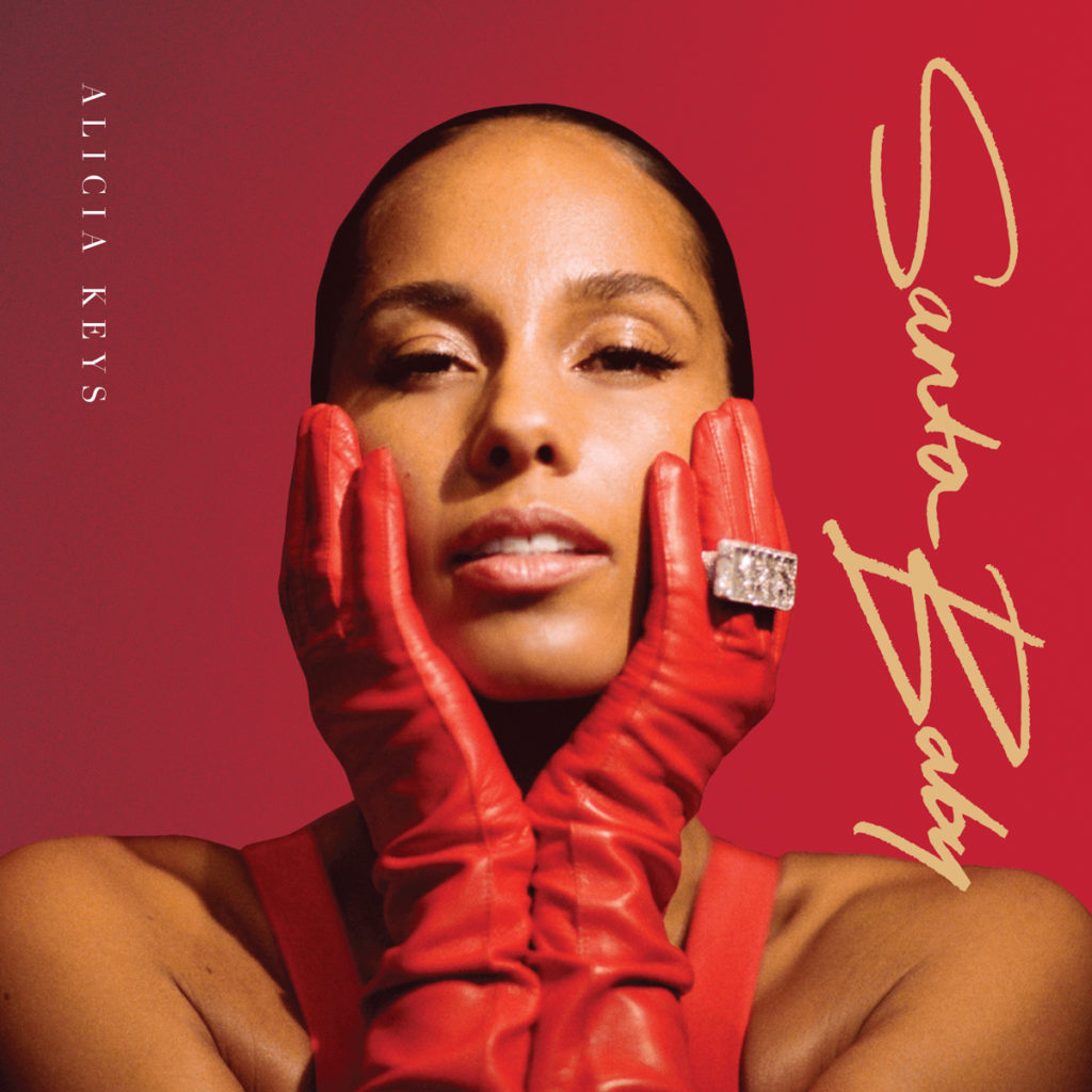 Alicia Keys holds her face in her hands wearing red leather gloves on the cover of her holiday-inspired album "Santa Baby." The album&squot;s first single, "December Back 2 June," released Oct. 28. (Courtesy of Alicia Keys Records)