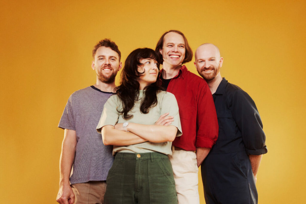 New Zealand indie rock group, The Beths, posted together in front of a yellow backdrop. (Courtesy of Carpark Records)