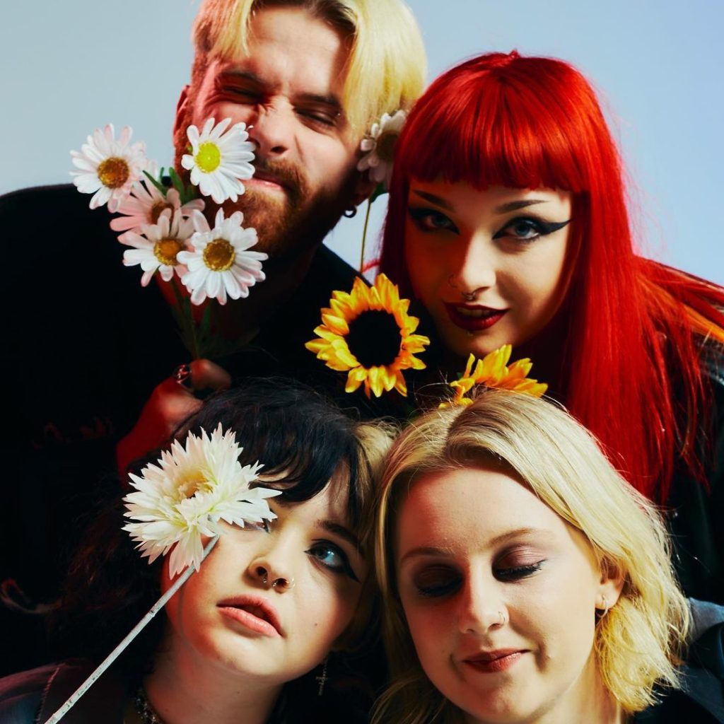 All four members of Crawlers pose together in front of a light blue background. The band released its single "That Time of Year Always” earlier this month. (Courtesy of Claryn Chong)