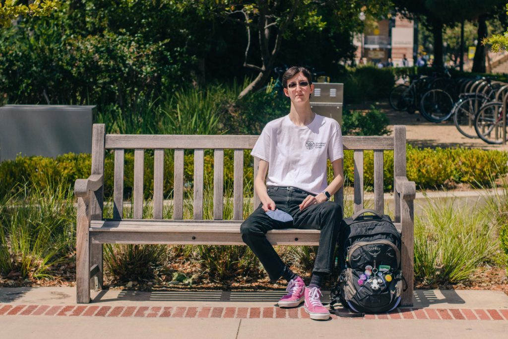 Fourth-year communication student Christopher Ikonomou, who has been using BruinAccess since 2019, sits on a bench near Ackerman Union. Ikonomou said he has been left behind by the van service before. (Javier Jauregui Ramirez/Daily Bruin)