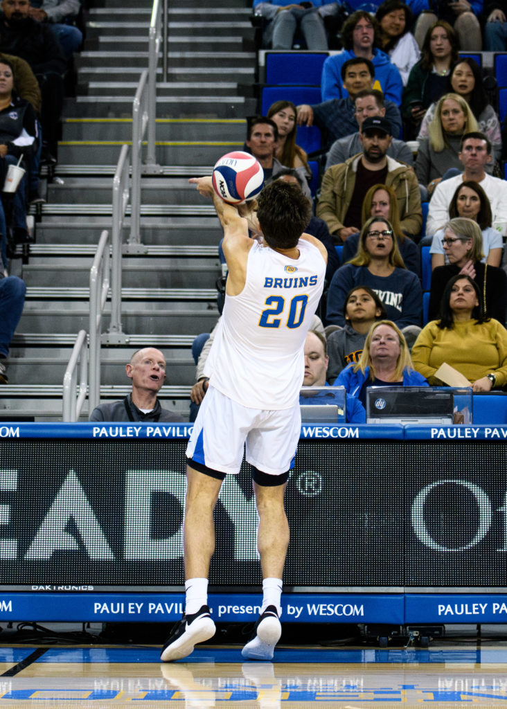 Ethan Champlin runs to the edge of the court to hit the ball. The junior outside hitter saved the Bruins’ chances of a sweep in the MPSF tournament with a kicksave in the third set.