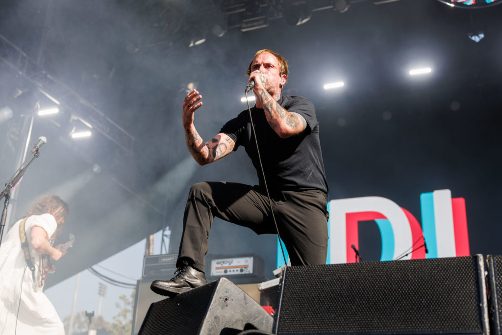 With his foot propped up on a speaker, lead singer Joe Talbot grips his mic in a cloud of white light. Punk rock band IDLES shared assorted annecdotes with the day three crowd, drawing from British politics, LA and their personal experiences. (Anika Chakrabarti/Photo editor)