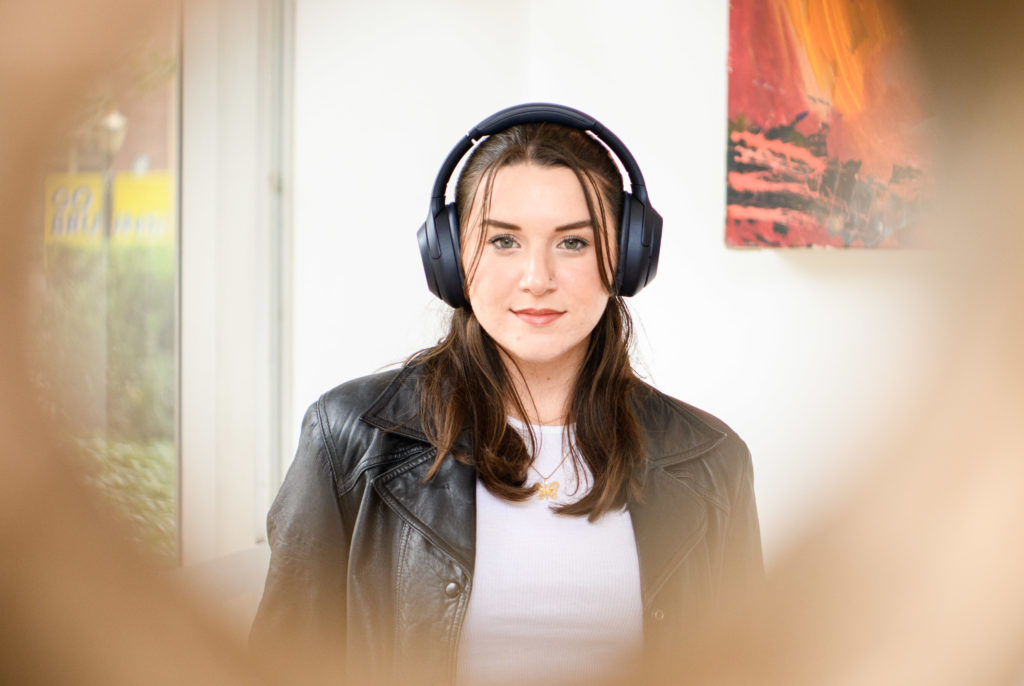 Heller stands dressed in black headphones and a leather jacket. The music promoter said she hopes to uplift female, non-binary and LGBTQ+ voices within the industry through her non-profit. (Christine Kao/Daily Bruin staff)