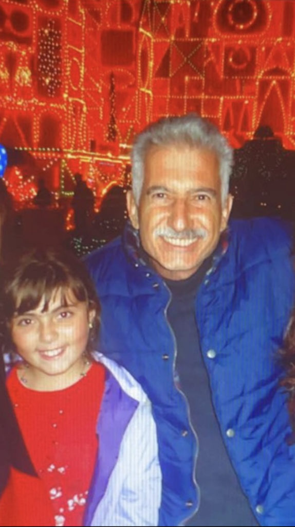 Nalbandian and her father stand in front of the Disneyland attraction "It&squot;s a Small World", brightly decorated to celebrate Christmas. (Courtesy of Sarah Nalbandian)