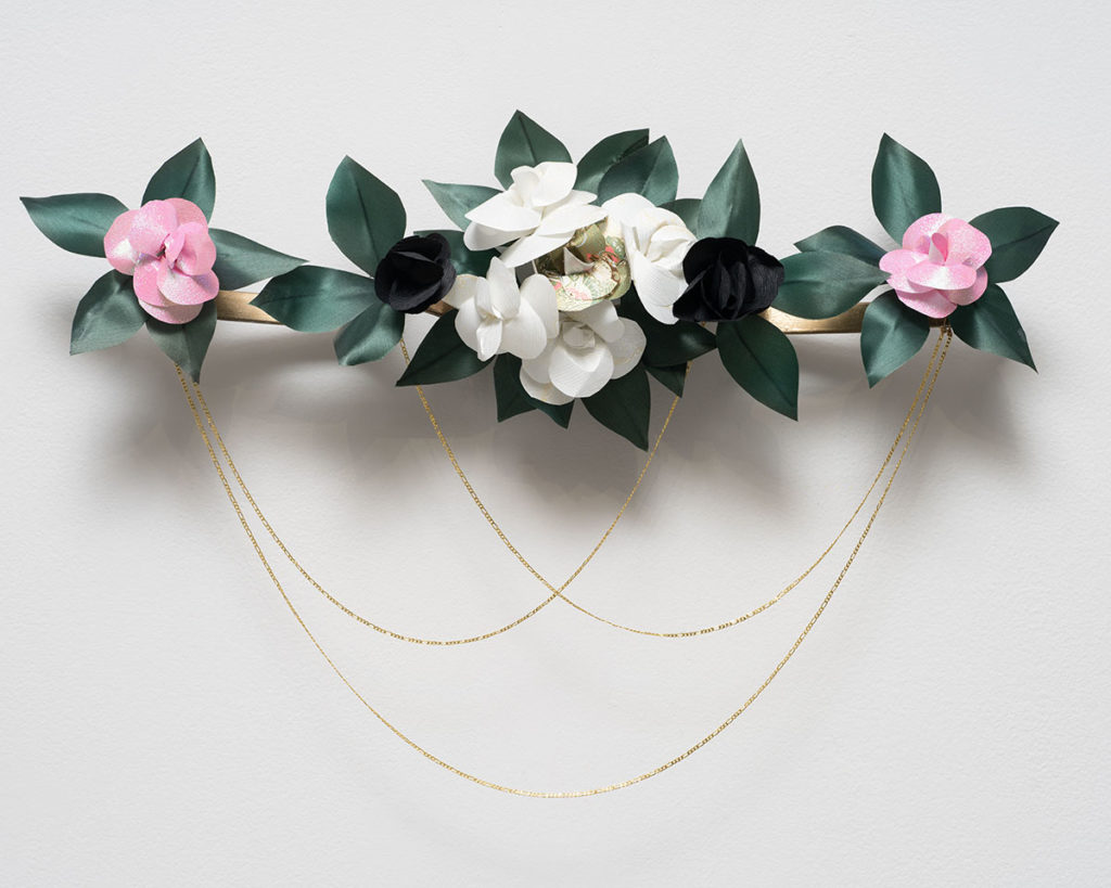 Thin gold chains dangle from neighboring washi paper flowers. "En Memoria #3" is one of School of the Arts and Architecture alumnus Shizu Saldamando&squot;s submissions to "Ahorita!" (Photo by Yubo Dong, Courtesy of Charlie James Gallery)