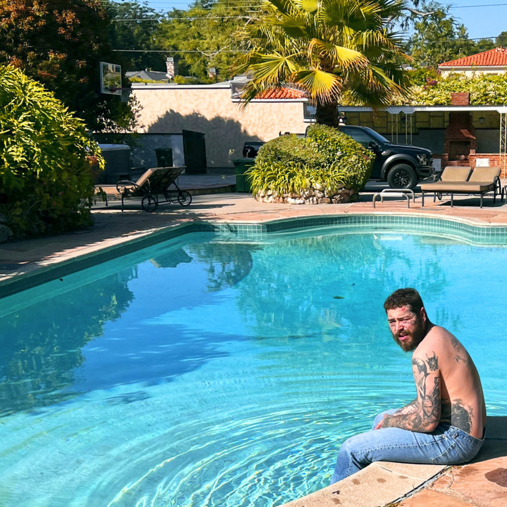 Austin, better known as Post Malone, sits on a pool ledge. The singer's self-titled album will be available on July 28. (Courtesy of Mercury Records / Republic Records)