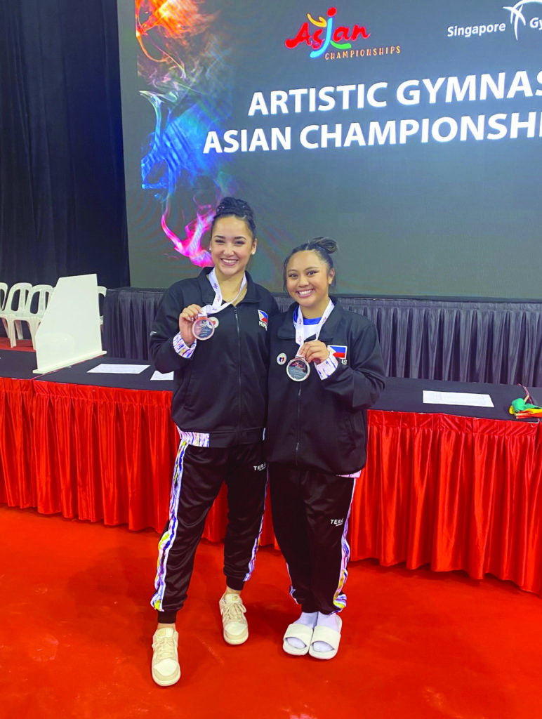 LSU gymnast Aleah Finnegan (left) poses with Malabuyo (right) as the duo shows their medals won with the Philippines at the Asian Championships. (Courtesy of Emma Malabuyo)