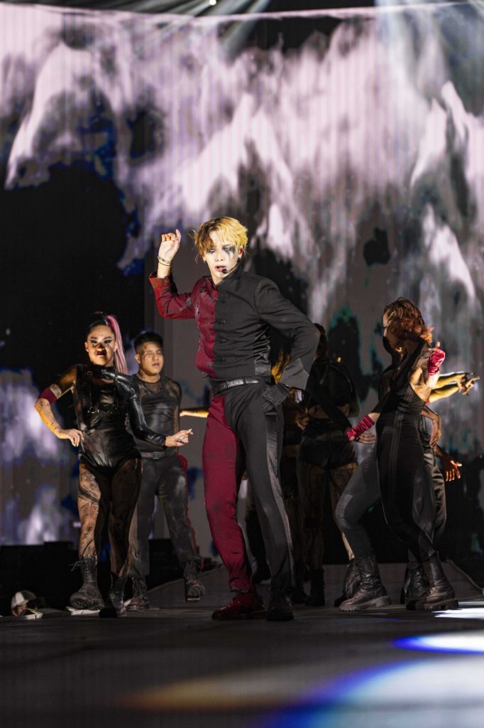 Surrounded by backup dancers and on-screen images of haze, Jackson Wang took the stage in a half-crimson, half-black suit. The headliner's performance began shortly after 10 p.m. (Megan Cai/Daily Bruin senior staff)