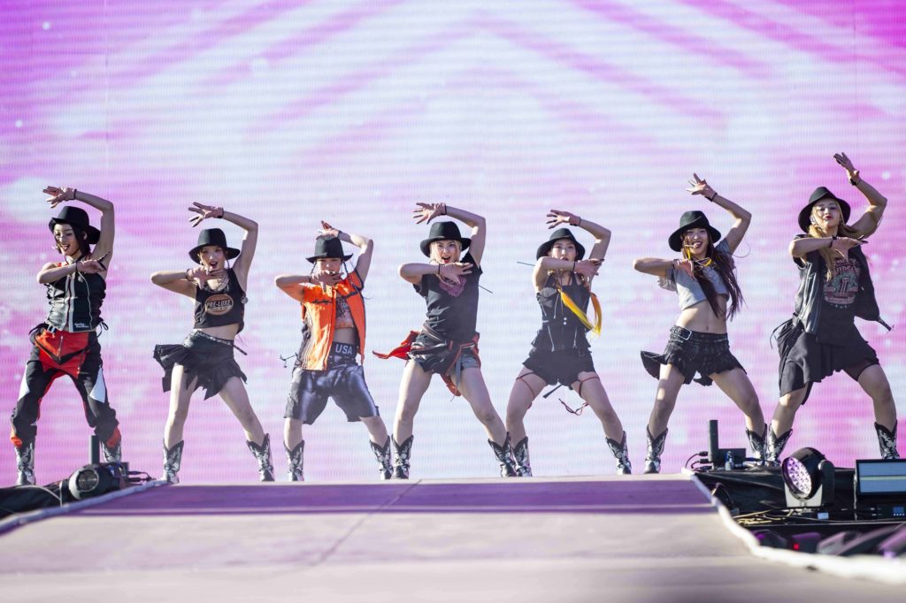 Wearing matching black cowboy hats, multinational group XG dances in front of a pink digital display. XG&squot;s dance-heavy setlist included the tracks "LEFT RIGHT," "SHOOTING STAR" and "GRL GVNG," among others. (Megan Cai/Daily Bruin senior staff)