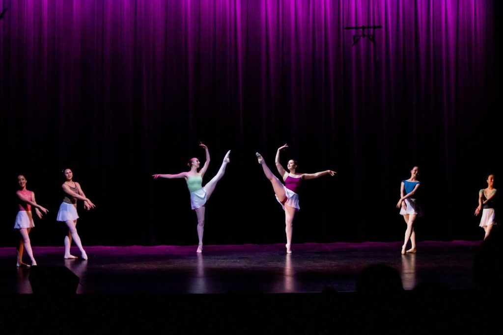 Six dancers perform on stage against a backdrop of mangeta-lit curtains. Social chair of the club and rising second-year microbiology, immunology and molecular genetics student Sara Habibipour said the organization's performances are free to attend and there is no audition requirement to join. (Courtesy of Alex Aljouni)