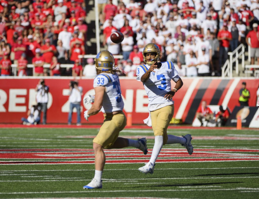 Freshman quarterback Dante Moore attempts a pass to junior running back Carson Steele. (Megan Cai/Daily Bruin senior staff)
