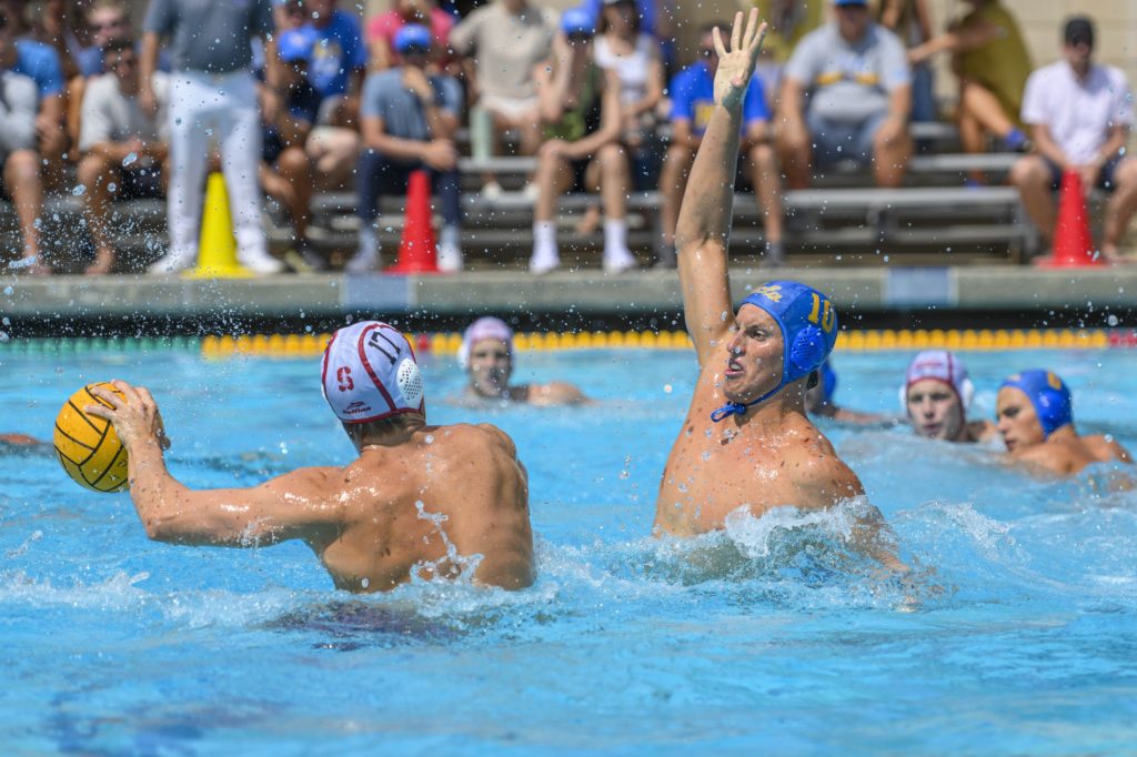 Redshirt senior attacker Jack Larsen lifts his arm upward in a defensive position against Stanford at Spieker Aquatics Center on Sept. 9. (Julia Zhou/Assistant Photo editor)