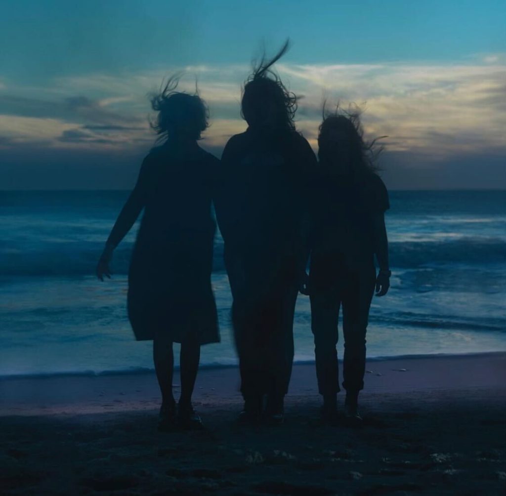 The three boygenius bandmates stand together on the shore for the cover of "the rest." Composed of Phoebe Bridgers, Lucy Dacus and Julien Baker, the alt-rock supergroup will release its second EP on Oct 13. (Courtesy of Interscope Records)
