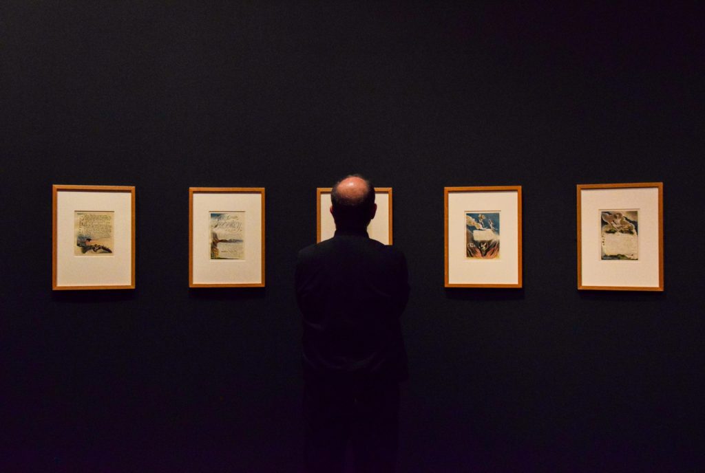 A guest views a series of illustrated works from poet and artist William Blake. Among the included works are Blake&squot;s “Songs of Innocence” and "Songs of Experience,” which are illustrated moral texts for children. (Myka Fromm/Assistant Photo editor)