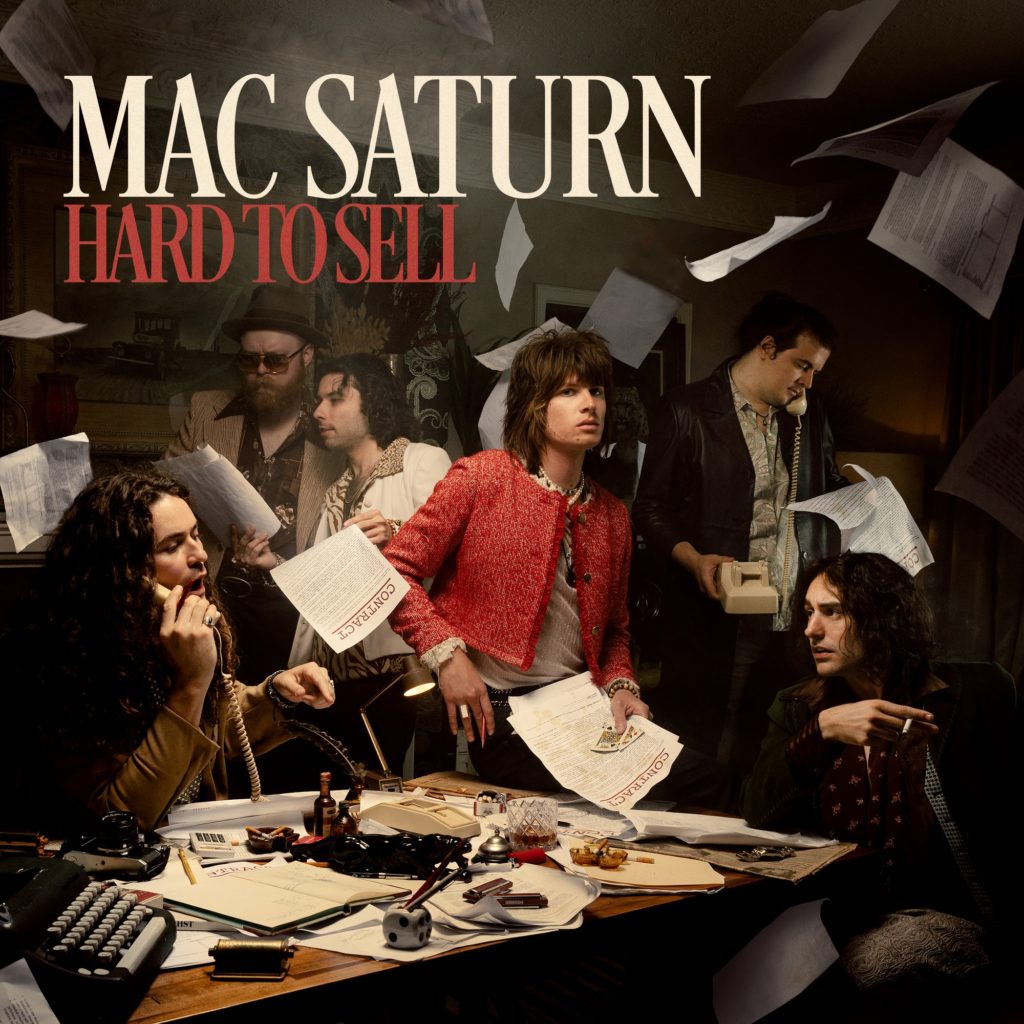 Detroit band Mac Saturn is surrounded by falling papers, reading "Contract" in large red letters. Its debut album, "Hard To Sell," will release on Jan. 26, coinciding with the first stop on the "Hard To Sell Tour." (Courtesy of Saturn Sounds)