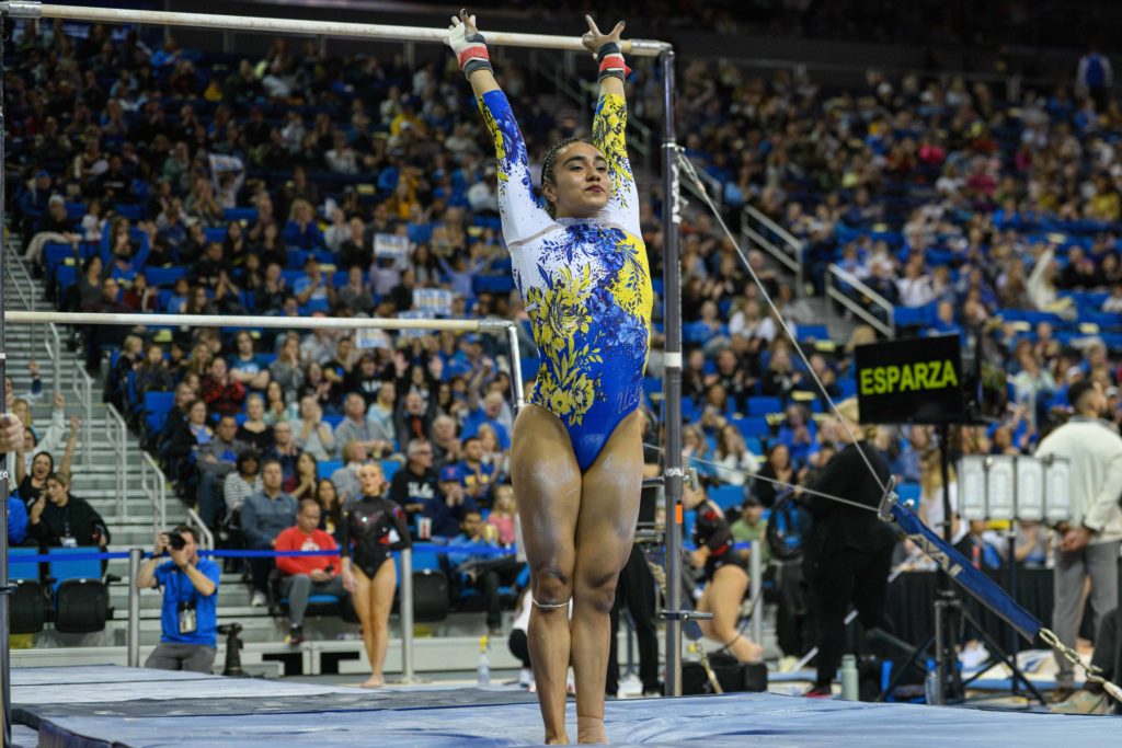 Senior Frida Esparza salutes the judges after her bars routine. Esparza is one of many “bubble” athletes, weaving in and out of lineups as the postseason nears. (Myka Fromm/Photo editor)
