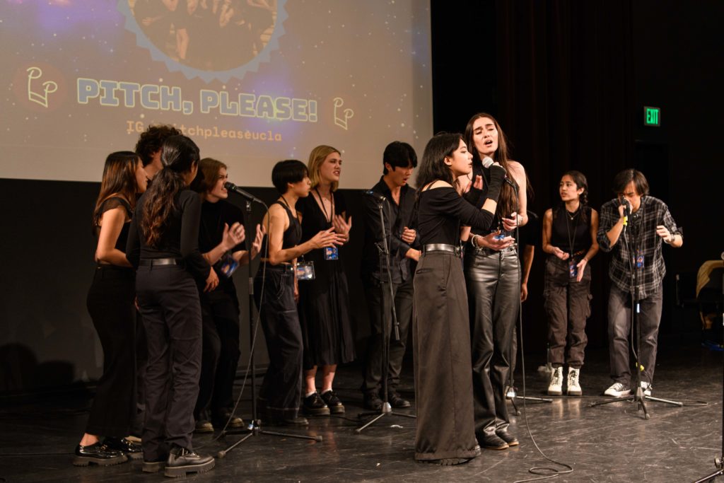 Co-ed Bruin a cappella group Pitch, Please! performs on stage. Its mash-up included tracks from Phoebe Bridgers and My Chemical Romance. (Nicolas Greamo/Daily Bruin senior staff)