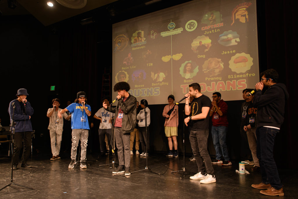 Bruin and Trojan beatboxers participate in a freestyle session on stage. President of the Beatboxing Bruins, Maxwell Tsao said though they battled, the artform is what ultimately brought the two teams together. (Nicolas Greamo/Daily Bruin senior staff)