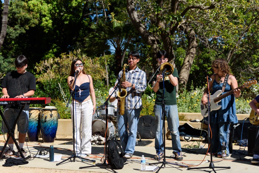 Some Garden Party bandmates close out the botanical garden's event following sets from 287vinyl and Old Growth. Bassist Sara Gorman said her vision for the event was brought to life with logistical assistance from the botanical garden's Olivia Slaby. (Dylan Du/Daily Bruin senior staff)