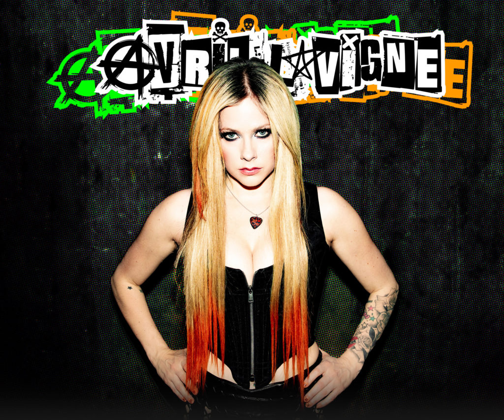 Sporting blonde hair with red tips, Avril Lavigne poses with hands on hips. The "What The Hell" singer will embark on her Greatest Hits tour which includes a performance at the Kia Forum at the end of May. (Courtesy of Avril Lavigne)