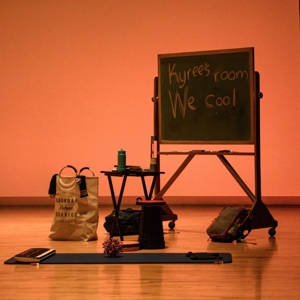 Dtawing inspiration from childhood, the set elements for "We Cool" include a chalkboard, yoga mat and keyboard. Alexander said the performance draws inspiration from her teddy bear-led conversations with her brother, whom she founded Crayons and Cookies with. (Nina Schmidt/Daily Bruin)