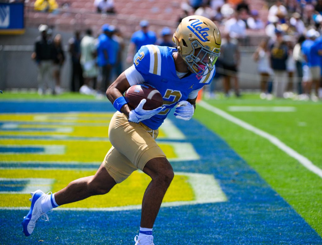 Junior wide receiver Titus Mokiao-Atimalala takes the ball out of the end zone at the Spring Showcase. After missing the 2023 season to injury, Mokiao-Atimalala figures to be a large factor in the Bruins' receiving room this fall. (Zimo Li/Daily Bruin)