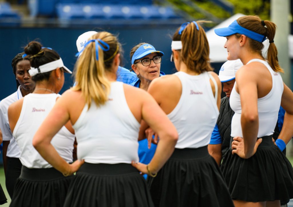 Coach Stella Sampras Webster coaches her team as the players gather around her. (Brianna Carlson/Daily Bruin)