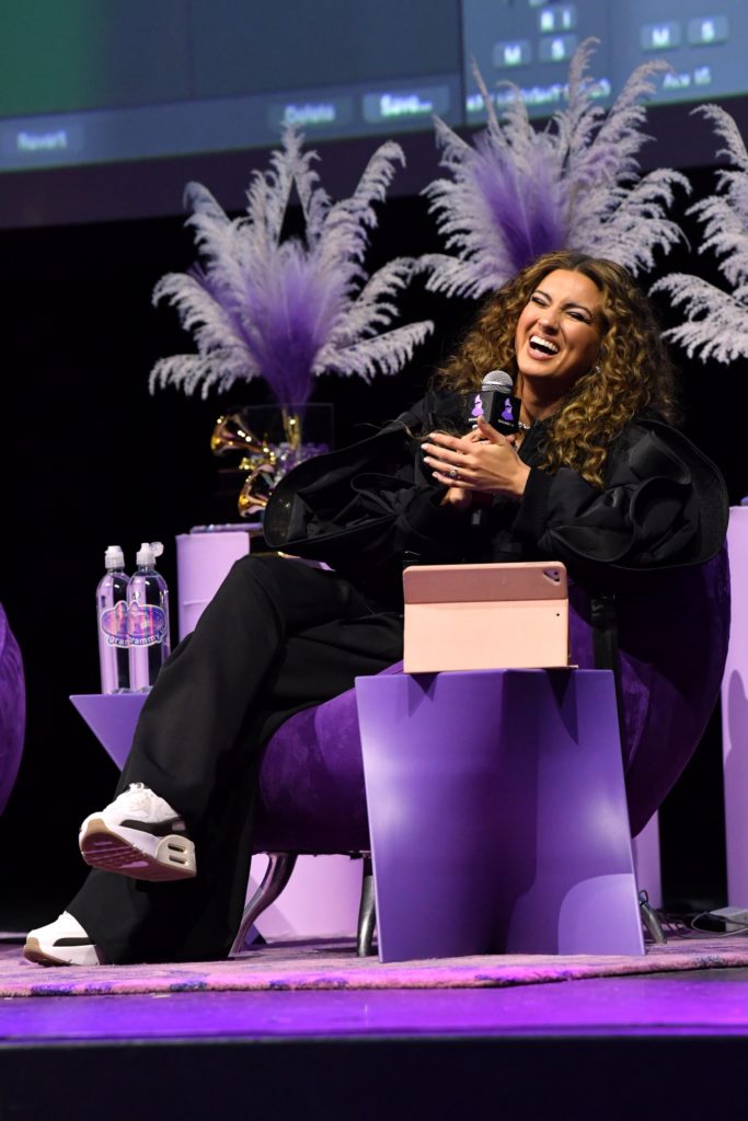 Tori Kelly leans back inher chair smiling during the workshop. After narrating the production for a handful of songs from "TORI.," the "cut" vocalist concluded with a performance of "oceans" and "high water." (Courtesy of Sarah Morris/Getty Images for the Recording Academy)