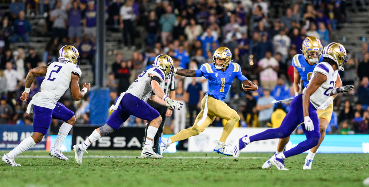 Washington defenders converge as then-quarterback Dorian Thompson-Robinson scrambles at the Rose Bowl in 2022. (Daily Bruin file photo)