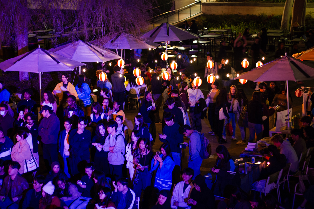 Attendees watch performances and visit vendors at the Matsuri festival. A crowd of over 500 students attended the inaugural event. (Max Zhang/Daily Bruin)