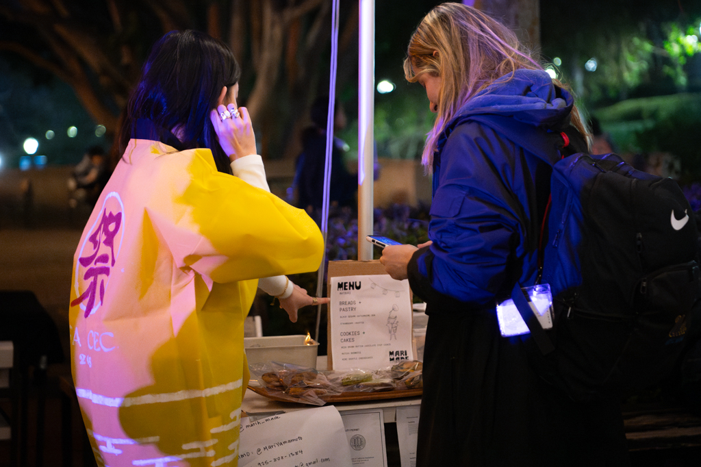 Attendees visit a vendor at the Matsuri festival. Vendors offered a multicultural range of activities from a Japanese fortune-telling booth to a mahjong station run by the Taiwanese Student Association. (Jessica Allen/Daily Bruin)